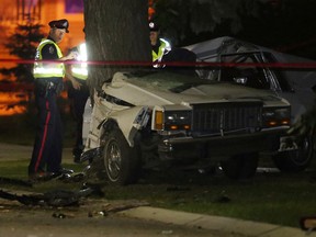 Police investigate at the scene of a fatal car accident along 151 Street north of 95 Avenue, in Edmonton Alta., on Sunday Aug. 24, 2014. Two people in the car were pronounced dead at the scene. Police believe speed and alcohol  were factors. David Bloom/Edmonton Sun/QMI Agency