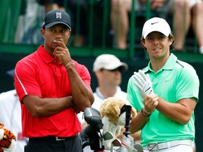 Tiger Woods of the U.S. talks to Rory McIlroy of Northern Ireland on the tee of the 12th hole during the final round of the Memorial Tournament at Muirfield Village Golf Club in Dublin, Ohio in this file photo from June 2, 2013.  (REUTERS)