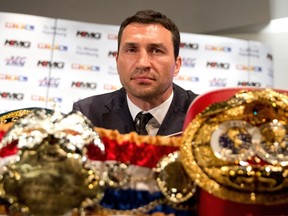 WBO and WBA boxing heavyweight champion, Wladimir Klitschko (L) of Ukraine is pictured during a press conference at the O2 World in Hamburg, northern Germany on June 25, 2014. (AFP PHOTO)