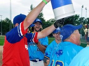 Bill Walt (right) is showered with ice water by son Jeff much to the delight of Nick Elligsen and Tyler Elligsen and other members of the Mitchell Grizzlies slo-pitch team after their 'A' championship of the Mitchell Men's Slo-pitch League Sunday, Aug. 24. ANDY BADER/MITCHELL ADVOCATE