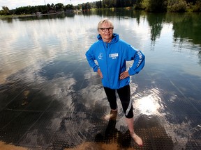 Pres­ident and Gen­er­al Man­ager of the World Tri­ath­lon Grand Final Sheila O'Kelly stands in the pond at Hawrelak Park, the site of next weekend's ITU World Triathlon Grand Final, in Edmonton Alta., on Sunday Aug. 24, 2014. (David Bloom/Edmonton Sun)