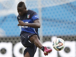 Italy's national soccer players Mario Balotelli attends a training session at the Dunas Arena soccer stadium in Natal June 23, 2014. (REUTERS/Toru Hanai)
