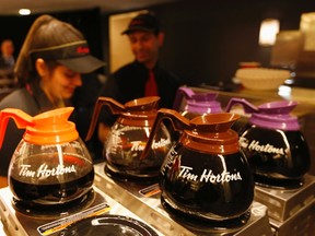 Tim Hortons employees prepare coffee before the company's annual general meeting in Toronto, in this file photo taken May 8, 2014. Burger King Worldwide is in talks to buy Canadian coffee and doughnut chain Tim Horton's in a deal that would be structured as a tax inversion to move the hamburger chain's domicile out of the United States.  REUTERS/Peter Jones/Files
