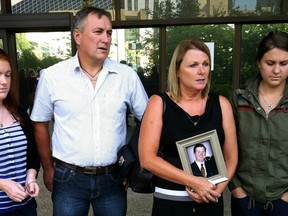 Left to right, homicide victim Kenzie Beaton's sister Miya, father A.J., mother Debbie (holding a photo of Kenzie) and sister Maggie stand outside the Edmonton Law Courts building after the sentencing of Cody Jensen to four years on a charge of manslaughter. Tony Blais/Edmonton Sun/QMI Agency