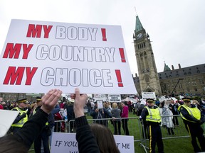 Pro choice activists demonstrates during an antiabortionist gather for the National March for Life on Parliament Hill in Ottawa, May 10, 2012.      Chris Roussakis/QMI Agency