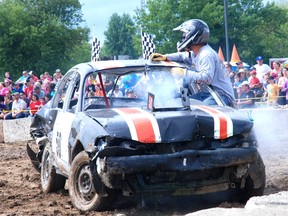 Clayton Berger of Middlemarch, climbs out of his car after being knocked out in a heat at the demolition derby at the Shedden Fair.
