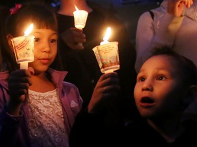 Xzavius Oxebin, 4, right, and his sister Tateanna, 6, take part in a candle light vigil at Sir Winston Churchill Square in Edmonton, AB on August 21, 2014 to remember missing and murdered Aboriginal women, most recently Tina Fontaine, 15, who was found wrapped in a bag and dumped in the Red River in Manitoba on Sunday. TREVOR ROBB/Edmonton Sun/QMI Agency