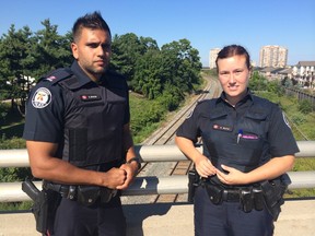 Consts. Gurminder Minhas, 30, and Alison Burns, 36, Monday, Aug. 25, 2014, on the Scarborough bridge from which they rescued a man who was threatening to jump on Friday afternoon. (Maryam Shah/Toronto Sun)