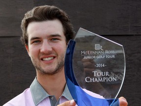 Jared Nichols holds up his  trophy from the McLnnan-Ross Tour championship at Wolf Creek on Monday. (David Bloom, Edmonton Sun)
