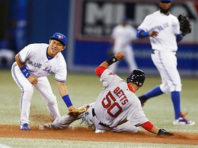 Toronto Blue Jays second baseman Munenori Kawasaki is late tagging Boston Red Sox outfielder Mookie Betts at the Rogers Centre in Toronto, August 25, 2014. (MICHAEL PEAKE/QMI Agency)