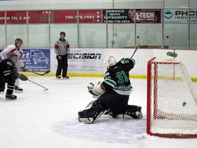 Brodyn Nielsen of the Whitecourt Wolverines sends the puck past Drayton Valley netminder Garrett Mason to score the Wolverines only point in pre-season play on Saturday, Aug. 23. Nielson’s goal was assisted by Jason Hamilton. Bryan Passifiume photo | QMI Agency