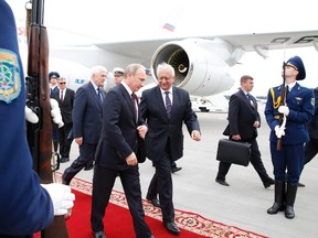 Russian President Vladimir Putin (L, front) speaks with Belarussian Prime Minister Mikhail Myasnikovich (R, front) during a welcoming ceremony at an airport outside Minsk, August 26, 2014. Russia and Ukraine said on August 19 their presidents would meet together with top European Union officials in Belarus's capital of Minsk on August 26 to discuss their confrontation over Ukraine which has plunged relations to an all-time low. REUTERS/Vasily Fedosenko
