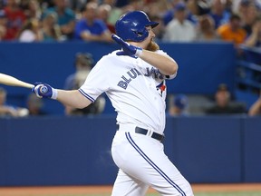 Blue Jays' Adam Lind hits a double in the fifth inning against the Boston Red Sox Tuesday night at the Rogers Centre. (Tom Szczerbowski/Getty Images/AFP)