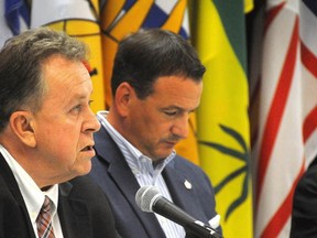 Gino Donato/The Sudbury Star   
Northern Development and Mines Minister Michael Gravelle makes a statement at a press conference as Greg Rickford, federal minister of Natural Resources and minister for the Federal Economic Development Initiative for Northern Ontario, listens.