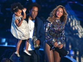 Jay-Z presents the Video Vanguard Award to Beyonce as he holds their daughter Blue Ivy during the 2014 MTV Video Music Awards in Inglewood, California August 24, 2014.  REUTERS/Kevork Djansezian