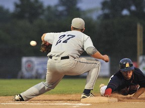 Pitcher Brett Sabourin of the London Majors (not show) falls short of picking off Kevin Atkinson of the Barrie Baycats at first, during game three IBL Final Series action at Schmidt and Shaw Stadium.   
(Mark Wanzel, The Barrie Examiner QMI )