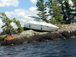 A boat was found on top of rocks on an island on Lake Nipissing after a crash. (Handout/QMI Agency)