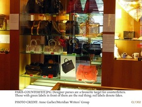 Designer purses are a favourite target for counterfeiters. Those with green labels in front of them are the real thing; red labels denote fakes. ANNE GARBER/MERIDIAN WRITERS’ GROUP