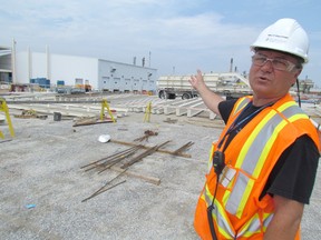 Kelly Gulliford, health and safety coordinator for BioAmber in Sarnia, points to a section of the construction site in Sarnia where the company's new plant is going up. Construction is expect to be completed by early 2015 on the plant company officials say is vitally important to its future.
PAUL MORDEN THE OBSERVER/ QMI AGENCY