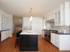 The Winfield has a base price of $702,000. Its kitchen is glorious with contrasting white and dark cabinetry.