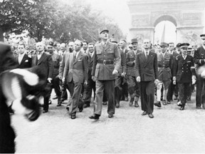 Gen. Charles de Gaulle and his entourage proudly stroll down the Champs Elysees to Notre Dame Cathedral for a service of thanksgiving following the city's liberation on Aug. 26, 1944.