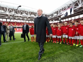 Russian President Vladimir Putin meets with young soccer players during a visit to the new Otkrytie Arena in Moscow on Wednesday, Aug. 27, 2014. (Sergei Karpukhin/Reuters)