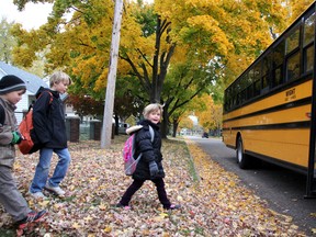 Lulu Banninga walks, in this file photo taken last November, to the bus with brothers Brett (left) and Cole behind her. Lulu was struck by an oncoming car on Oct. 17 and knocked unconscious. Her mother, Danna Banninga, is joining police in urging drivers, and parents, to take extra care as school buses return to the roads in the coming days. (FILE PHOTO/THE OBSERVER/QMI AGENCY)