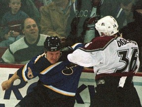 St. Louis Blues defenceman Rudy Poeschek (L) swings at Colorado Avalanche right wing Jeff Odgers during a fight in the first period in Denver in this 1999 file photo. (REUTERS)