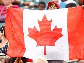 A Canadian fan flies his flag during the second half of FIFA U-20 World Cup quarterfinals game with Germany at Commonwealth Stadium in Edmonton Alta., on Aug. 16, 2014. Germany won 2-0. Ian Kucerak/Edmonton Sun/ QMI Agency