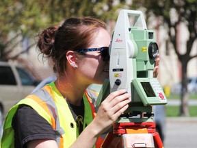 Survey technician Laura Haddon helps map out Centennial Park Wednesday afternoon. The City of Sarnia has hired Monteith & Sutherland Ltd. for a $25,000 topographical survey of the entire waterfront park in order for remediation work to begin this fall. (BARBARA SIMPSON, The Observer)