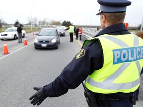 OPP Const. Rheal Levac takes part in a R.I.D.E. program at the 417 eastbound on ramp in Kanata last November. Ottawa Sun/QMI Agency