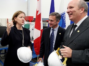 (left to right) Alberta Premier Alison Redford talks with NAIT's board chair James Cumming and NAIT's president and CEO Dr. Glenn Feltham, during the launch of NAIT's Trades-to-Degrees initiative at NAIT, Wednesday Nov. 14, 2012. The initiative will allow certified tradespeople to move from a trades certificate to the third year of a degree program. DAVID BLOOM EDMONTON SUN