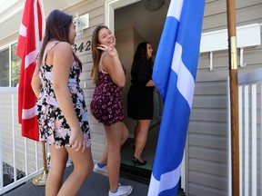 The Crouter Family Danette (left), Kenidy, and their mother Eunice goes into their new Habitat for Humanity home during a presentation in Edmonton, Alberta on August 27, 2014.  (Perry Mah/Edmonton Sun)