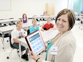 An open house was held Wednesday at Wallaceburg District Secondary School to give Grade 7 and 8 students a chance to see the renovations that have been made to accommodate them, beginning in September. WDSS vice-principal Lisa MacDonald is pictured here with new Grade 7 students, from left to right: Landon Allaer, 12, Owen Kerr, 12, Jacob Richmond, 11, and Hailey McCann, 12. (ELLWOOD SHREVE, The Daily News)