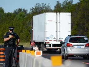 Napanee based traffic officer, Andrew Jocko monitors traffic in a construction zone along Highway 401 on Wednesday.