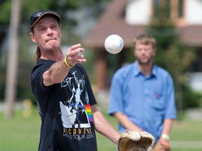 Stan Jacques releases the ball in a game of softball at McMahon Park in London Wednesday. The players, most of whom have fallen on hard times, are brought together for games organized by the Salvation Army. (CRAIG GLOVER, The London Free Press)