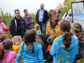 Jim Moodie/The Sudbury Star
Tammy Deamicis, community events programmer with the Greater Sudbury Public Library, reads a page from the children's book Samuel's Most Important Message during a Tales for Trails event at the Lake Laurentian Conservation Area on Wednesday evening. The story, by Frank Glew, communicates the importance of protecting habitat.