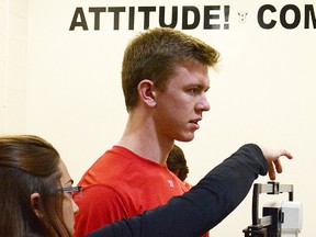Forward Brandon Saigeon, Belleville's first-round pick at the 2014 OHL draft, gets weighed-in by Bulls team official Jackie Jarrell during the opening of training camp Wednesday at the Sports Centre. (ZACHARY SHUNOCK/The Intelligencer)