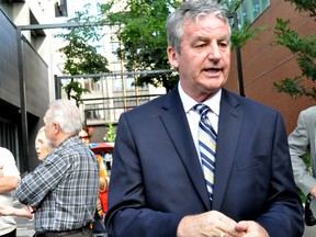 City councillor and mayoral candidate Joe Swan speaks to members of the public following a news conference at Covent Garden Market in London, Ont. August 28, 2014. Swan announced he will ask Fanshawe College president Peter Devlin to temporarily withdraw a $9 million funding request that would help the school purchase Kingsmill’s on Dundas Street. CHRIS MONTANINI\LONDONER\QMI AGENCY