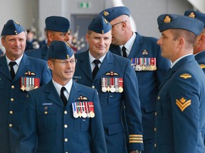 Incoming commanding officer (CO) of 436 Transport Squadron at 8 Wing/CFB Trenton, Ont. Lt. Col. Troy Paisley, third from left, inspects the parade along with the air base CO Col. David Lowthian, centre, and outgoing CO of 436 Lt. Col. Mark Goulden, left, during a change of command ceremony held in Hangar 1 Thursday, Aug. 28, 2014.  - JEROME LESSARD/THE INTELLIGENCER/QMI AGENCY
