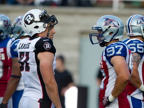 Patrick Lavoie (left) chats with former Alouettes teammate Aaron Lavarias. (QMI Agency)