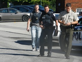 The scene in Gatineau Thursday morning as both provincial and municipal police surrounded a Hull apartment building in Mont Bleu where reports suggested a man had barricaded himself at 12 Tasse St. following an early morning shooting. (DOUG HEMPSTEAD/Ottawa Sun)