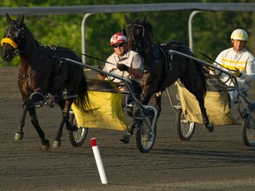 Lyons Again (left), with Shannon Murphy driving, and Lyons Levi Lewis, under assistant trainer Mickey Burke Jr., prepare for Saturday’s Metro Pace at Mohawk Racetrack. (Michael Burns/Photo)