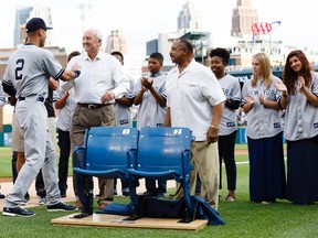 New York Yankees shortstop Derek Jeter (2) is presented with two seats from Tigers Stadium by Detroit Tigers former players Al Kaline (centre) and Willie Horton (right) before the game at Comerica Park in Detroit on Aug. 27, 2014.(RICK OSENTOSKI/USA TODAY Sports)