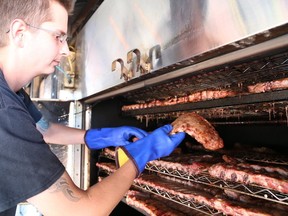 Gino Donato/The Sudbury Star
Peter Sakellis of Smoke House Bandits checks on some ribs in the smoker in preparation for Downtown Sudbury Ribfest in this file photo. The festival returns next weekend.