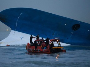 Maritime police search for missing passengers in front of the South Korean Sewol ferry which sank at sea, off Jindo, in this file picture taken April 16, 2014. South Korean families who lost loved ones in April's ferry disaster are demanding accountability from the government, but some have grown weary of strident activists adopting their cause for political ends.    REUTERS/Kim Hong-Ji/Files (SOUTH KOREA - Tags: DISASTER MARITIME)