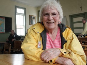 Pat Ross smiled for the camera while sitting at an antique desk found in the one-room schoolhouse on the museum's grounds during Picnic in the Past, an event co-ordinated by the MHC's staff to serve seniors who would otherwise be unable to visit the museum.