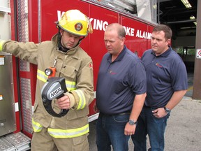 Chatham-Kent firefighter James Labombard demonstrates a new thermal imaging camera to Ian MacRobbie, general manager of Enbridge Green Energy, and John Bridges, site supervisor of Enbridge's Talbot wind farm. The company donated $13,500 to cover the cost of two new cameras for the fire department on Aug. 29.