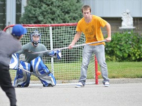 Jordan Whiteland, centre, and Nick Cotto focus on a shot by Joel Blancher as the trio played a little road hockey on First Avenue in Brockville, Ont. on  Wednesday, Sept. 4 2013 .
Darcy Cheek/QMI Agency file photo