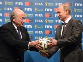 Russia's President Vladimir Putin (R) and FIFA President Sepp Blatter take part in the official hand over ceremony for the 2018 World Cup scheduled to take place in Russia, in Rio de Janeiro July 13, 2014.    (REUTERS/Alexey Nikolsky/RIA Novosti/Kremlin)